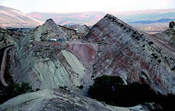 The Quarry Visitor Center perched upon steeply dipping Morrison Formation strata. Photo by Bill Hoesch.